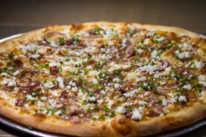 pizza caramellato with caramellized red oinions, goat cheese, and scallions